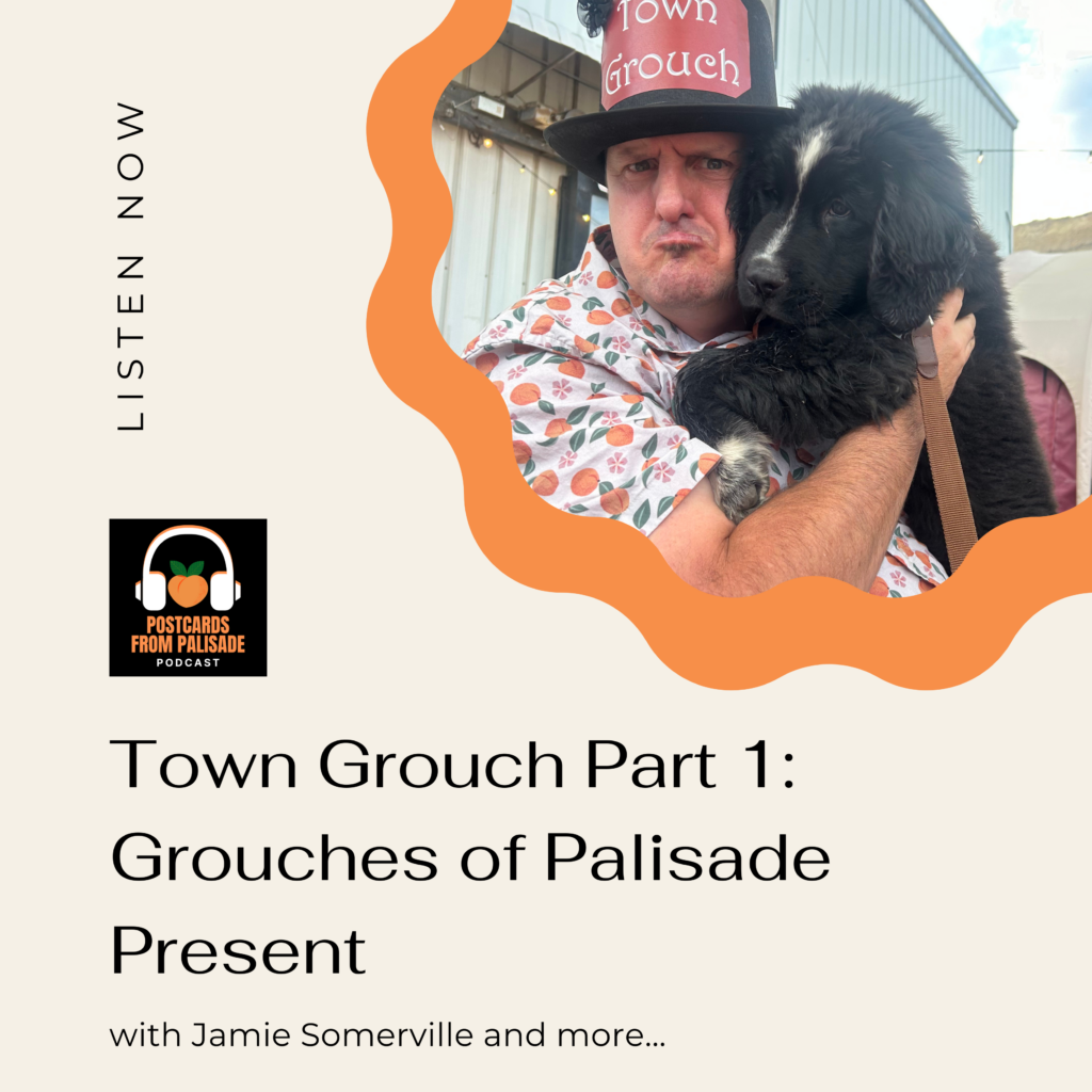 Palisade's town grouch, Jamie Somerville, frowns while holding a puppy